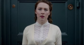 Movie still from “Brooklyn” (2015), directed by John Crowley – A woman in a white shirt and white sweater; Close Up shot, Low angle