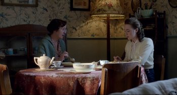 Movie still from “Brooklyn” (2015), directed by John Crowley – Two women sitting at a table in front of each other; Medium shot, High angle