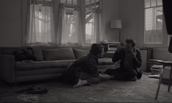 Movie still from “C'mon C'mon” (2021), directed by Mike Mills – Two people sitting on the ground in a living room; Wide shot, High angle