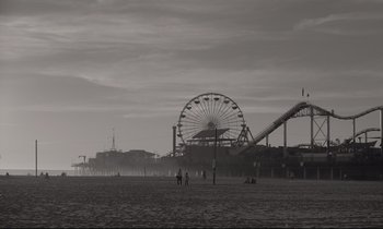 Movie still from “C'mon C'mon” (2021), directed by Mike Mills – Two people standing on a beach near a ferris wheel; Extreme Wide shot, Low angle
