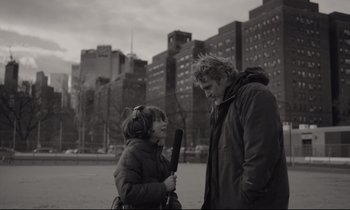 Movie still from “C'mon C'mon” (2021), directed by Mike Mills – A man and a woman standing next to each other in front of some buildings; Close Up shot, Over the shoulder angle