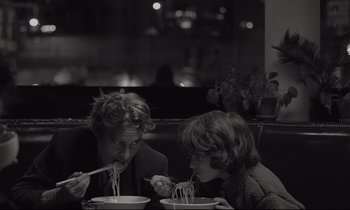 Movie still from “C'mon C'mon” (2021), directed by Mike Mills – A man and a woman sitting at a table with bowls of noodles; Close Up shot, Over the shoulder angle