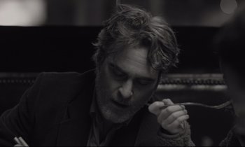 Movie still from “C'mon C'mon” (2021), directed by Mike Mills – Black and white photograph of a man holding a spoon; Close Up shot, Low angle