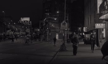 Movie still from “C'mon C'mon” (2021), directed by Mike Mills – A black - and - white photo of a city street at night; Wide shot, Low angle