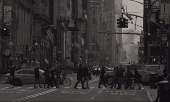 Movie still from “C'mon C'mon” (2021), directed by Mike Mills – A black and white photo of people crossing the street; Wide shot, High angle