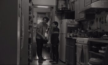 Movie still from “C'mon C'mon” (2021), directed by Mike Mills – Two people standing in a kitchen next to each other; Medium shot, Over the shoulder angle