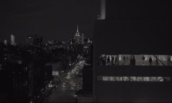 Movie still from “C'mon C'mon” (2021), directed by Mike Mills – A view of a city at night from a building; Extreme Wide shot, Low angle