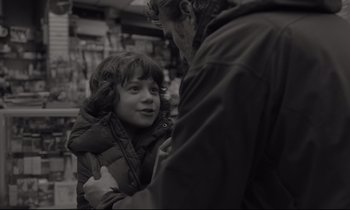 Movie still from “C'mon C'mon” (2021), directed by Mike Mills – A young girl is being hugged by an older man; Close Up shot, Over the shoulder angle