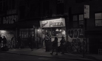 Movie still from “C'mon C'mon” (2021), directed by Mike Mills – A group of people walking down the sidewalk of a city street; Extreme Wide shot, High angle