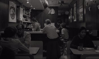 Movie still from “C'mon C'mon” (2021), directed by Mike Mills – A group of people sitting at a table in a restaurant; Wide shot, Over the shoulder angle