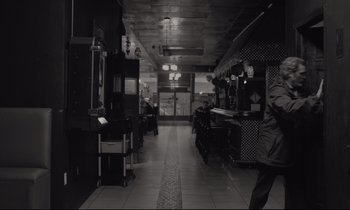 Movie still from “C'mon C'mon” (2021), directed by Mike Mills – A black - and - white photo of an empty restaurant; Wide shot, High angle