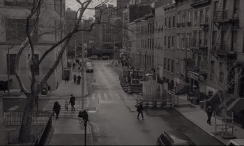 Movie still from “C'mon C'mon” (2021), directed by Mike Mills – A black and white photo of people walking down a street; Extreme Wide shot, High angle