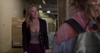 Movie still from “CODA” (2021), directed by Sian Heder – A woman in a leopard print top and a black jacket; Medium shot, Over the shoulder angle