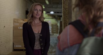 Movie still from “CODA” (2021), directed by Sian Heder – A woman standing in a building looking at another woman; Medium shot, Over the shoulder angle