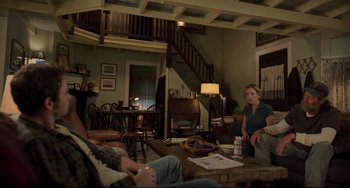 Movie still from “CODA” (2021), directed by Sian Heder – A group of people sitting around a table in a living room; Wide shot, Over the shoulder angle