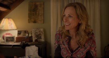 Movie still from “CODA” (2021), directed by Sian Heder – A woman sitting in front of a mirror smiling; Close Up shot, Over the shoulder angle