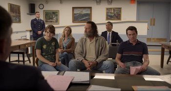 Movie still from “CODA” (2021), directed by Sian Heder – A group of people sitting around a table; Medium shot, Over the shoulder angle