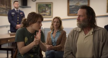 Movie still from “CODA” (2021), directed by Sian Heder – Two women and an older man are sitting in a room; Medium shot, Over the shoulder angle