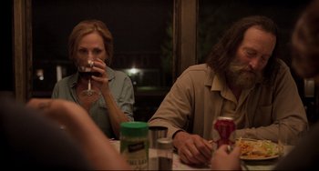 Movie still from “CODA” (2021), directed by Sian Heder – Two people sitting at a dinner table drinking wine; Medium shot, Over the shoulder angle