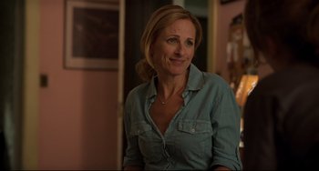 Movie still from “CODA” (2021), directed by Sian Heder – A woman in a blue shirt is smiling; Close Up shot, Over the shoulder angle