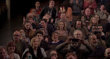 Movie still from “CODA” (2021), directed by Sian Heder – A group of people sitting in a room with cell phones; Wide shot, High angle
