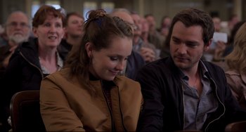 Movie still from “CODA” (2021), directed by Sian Heder – A woman sitting in front of a group of people; Close Up shot, Over the shoulder angle