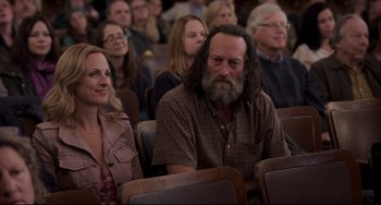 Movie still from “CODA” (2021), directed by Sian Heder – A group of people sitting together in a room; Medium shot, Over the shoulder angle