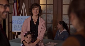 Movie still from “CODA” (2021), directed by Sian Heder – A woman standing next to a little girl in a pink jacket; Medium shot, Over the shoulder angle