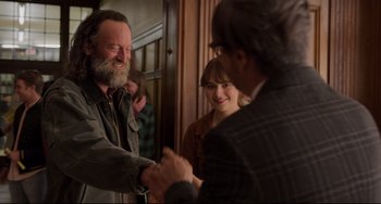 Movie still from “CODA” (2021), directed by Sian Heder – A man and a woman shaking hands in front of another man; Medium shot, Over the shoulder angle