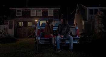 Movie still from “CODA” (2021), directed by Sian Heder – Two people sitting in the back of a truck at night; Wide shot, Over the shoulder angle