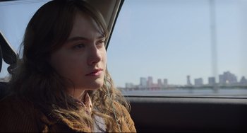 Movie still from “CODA” (2021), directed by Sian Heder – A woman sitting in the back seat of a car looking out the window; Close Up shot, Over the shoulder angle