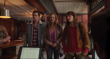 Movie still from “CODA” (2021), directed by Sian Heder – A group of people standing next to each other in front of a computer; Medium shot, Over the shoulder angle