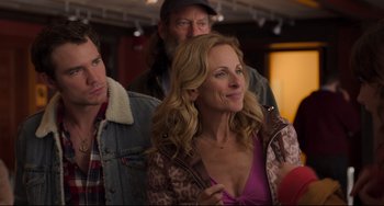 Movie still from “CODA” (2021), directed by Sian Heder – A man and a woman standing next to each other in front of another man; Close Up shot, Over the shoulder angle