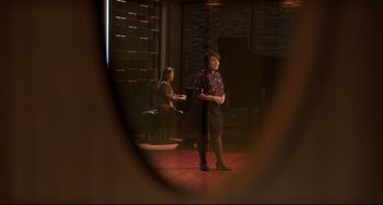 Movie still from “CODA” (2021), directed by Sian Heder – A woman standing on a stage in front of a mirror; Wide shot, Over the shoulder angle