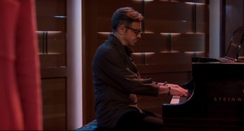 Movie still from “CODA” (2021), directed by Sian Heder – A man sitting at a piano in front of a window; Medium shot, Over the shoulder angle