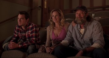 Movie still from “CODA” (2021), directed by Sian Heder – A group of people sitting on top of a couch; Medium shot, Over the shoulder angle