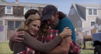 Movie still from “CODA” (2021), directed by Sian Heder – Three people hugging each other in the street; Medium shot, Over the shoulder angle