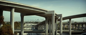 An empty freeway with a city in the background