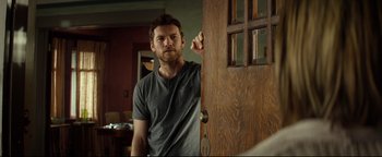 A man standing in front of an open door