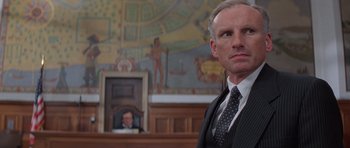 Movie still from “Carlito's Way” (1993), directed by Brian De Palma – A man in a suit and tie in a court room; Close Up shot, Low angle