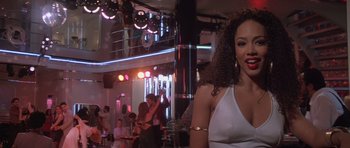 Movie still from “Carlito's Way” (1993), directed by Brian De Palma – A woman in a white dress is in a bar; Close Up shot, Over the shoulder angle