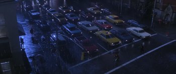 Movie still from “Carlito's Way” (1993), directed by Brian De Palma – A bunch of cars are parked in a parking lot; Extreme Wide shot, High angle