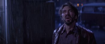 Movie still from “Carlito's Way” (1993), directed by Brian De Palma – A man with a beard and a wet shirt on; Close Up shot, Low angle