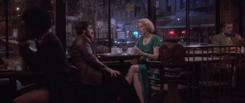 Movie still from “Carlito's Way” (1993), directed by Brian De Palma – A man and a woman sitting at a table in front of each other; Wide shot, High angle