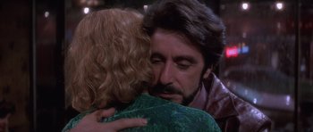 Movie still from “Carlito's Way” (1993), directed by Brian De Palma – A man and a woman hugging each other; Close Up shot, Over the shoulder angle