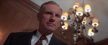 Movie still from “Carlito's Way” (1993), directed by Brian De Palma – A person wearing a suit and tie; Close Up shot, Low angle