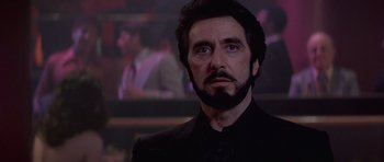 Movie still from “Carlito's Way” (1993), directed by Brian De Palma – A person wearing a suit and beard; Close Up shot, Low angle