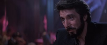 Movie still from “Carlito's Way” (1993), directed by Brian De Palma – A person wearing a suit and beard; Close Up shot, Over the shoulder angle