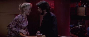 Movie still from “Carlito's Way” (1993), directed by Brian De Palma – A man and a woman are talking at a bar; Close Up shot, Over the shoulder angle