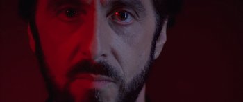 Movie still from “Carlito's Way” (1993), directed by Brian De Palma – A man's face with red light shining on it; Extreme Close Up shot, Low angle